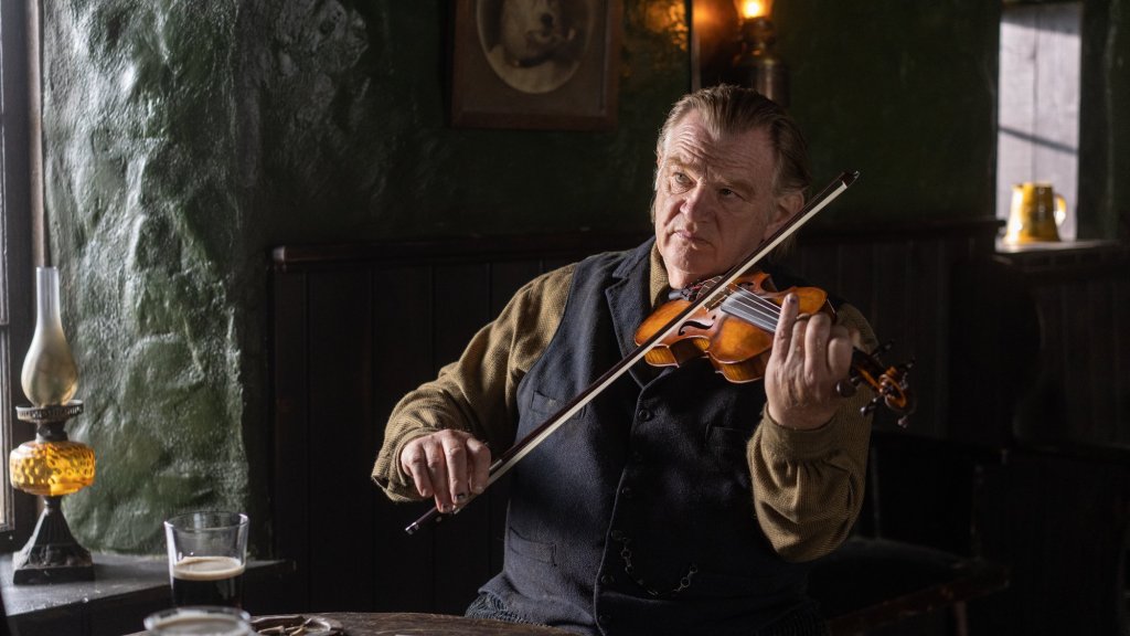 An image of Colm playing his violin in a pub.